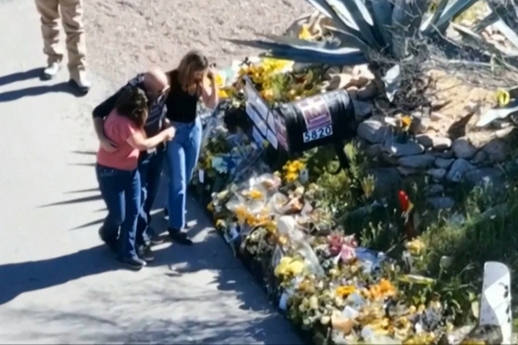 Savannah Guthrie, right, her sister Annie Guthrie, left, and her brother-in-law Tommaso Cioni, Monday, March 2, 2026, visiting a tribute to their mother Nancy Guthrie.