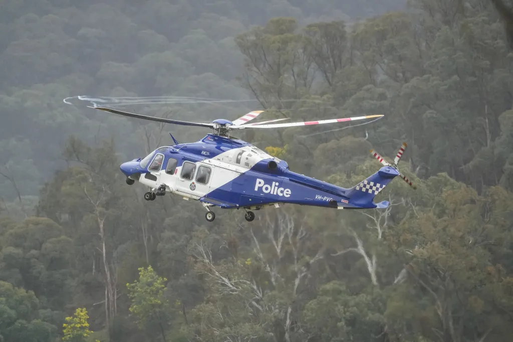 A police helicopter flies during the search for fugitive Dezi Freeman near a staging area in Porepunkah, Victoria, Australia, on Aug. 28, 2025.
