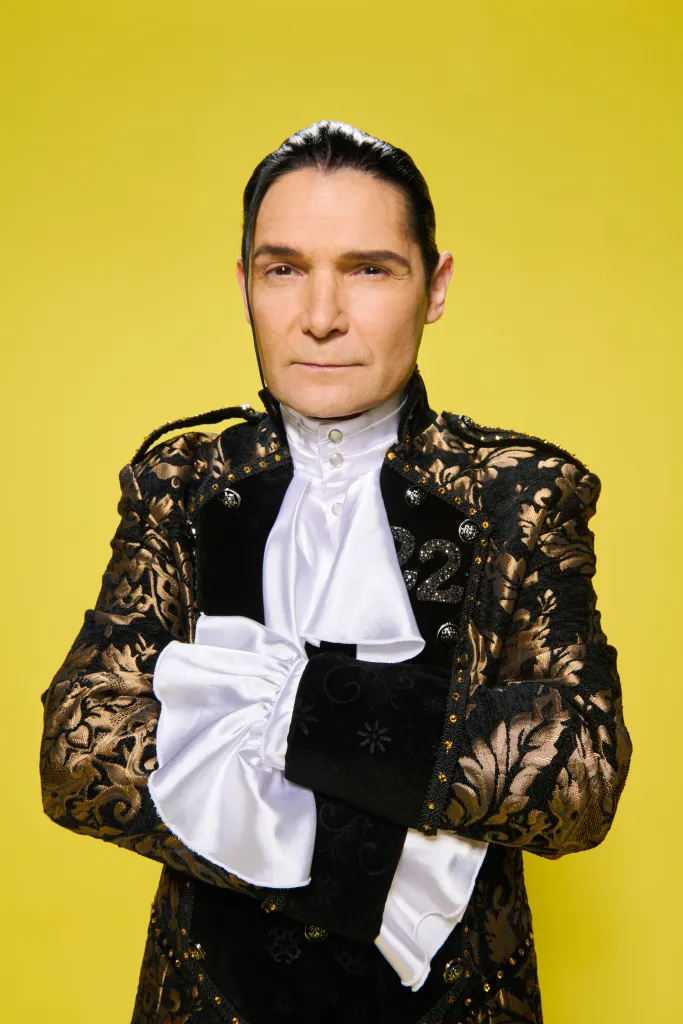 Corey Feldman posing for a portrait in a period costume.