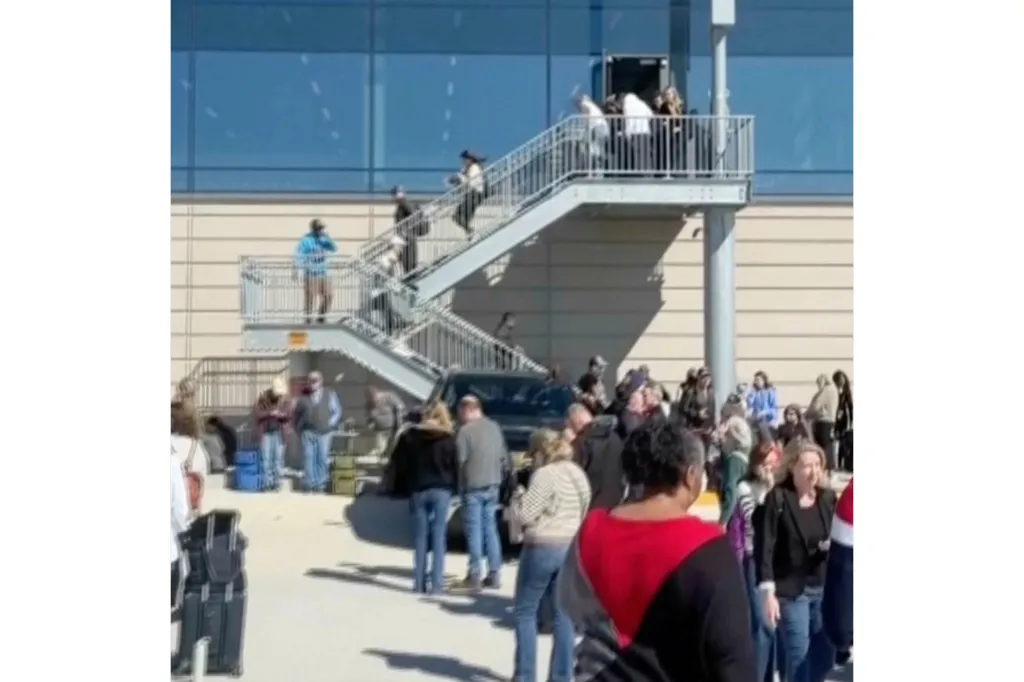 People standing outside terminals at the Kansas City International Airport.