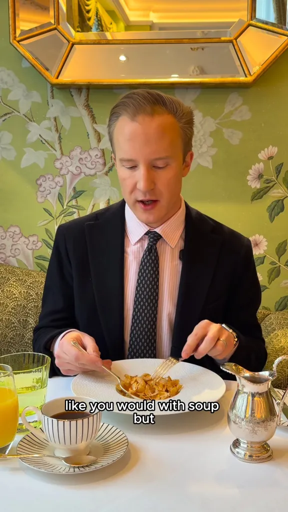 William Hanson demonstrating how to properly eat cereal with two utensils.
