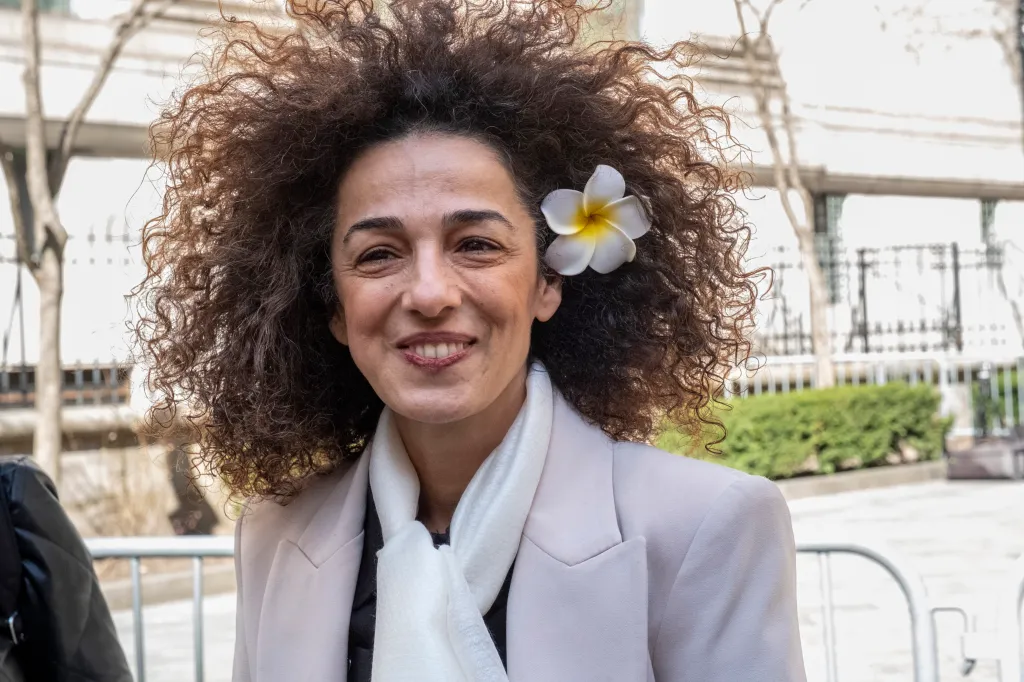 Iranian journalist Masih Alinejad smiling while leaving Manhattan Federal Court.