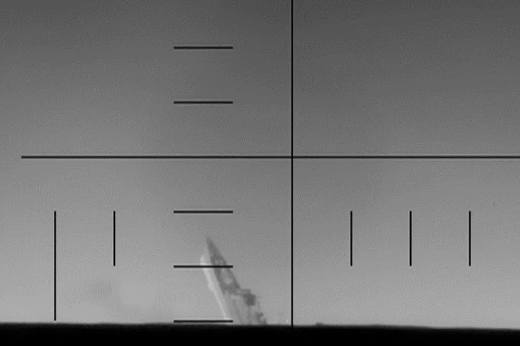 View from a U.S. submarine of an Iranian naval vessel sinking in the Indian Ocean.