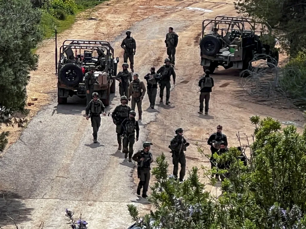 Israeli soldiers and military vehicles at the Israel-Lebanon border.