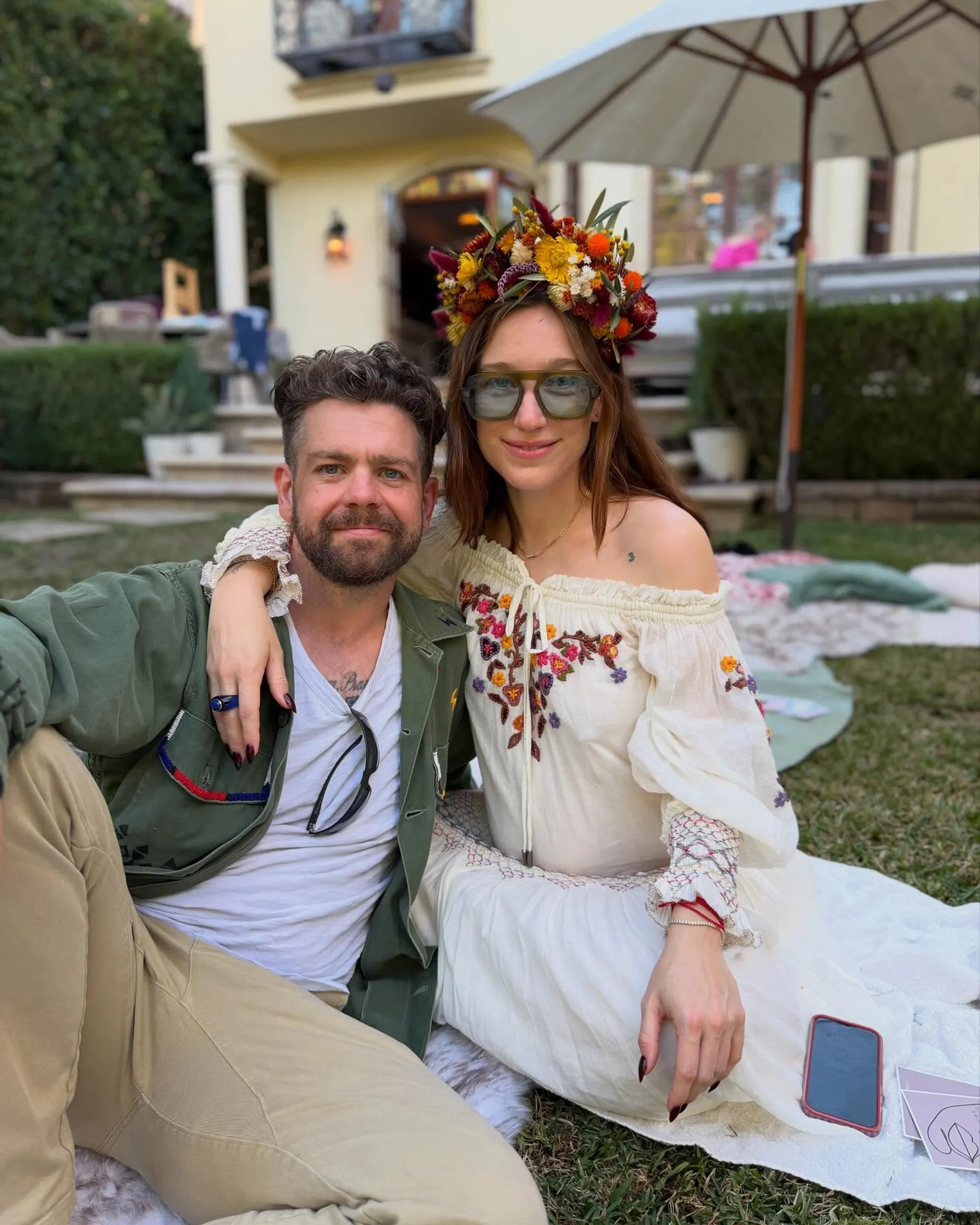 Jack Osbourne and Aree Gearhart sitting on the grass.