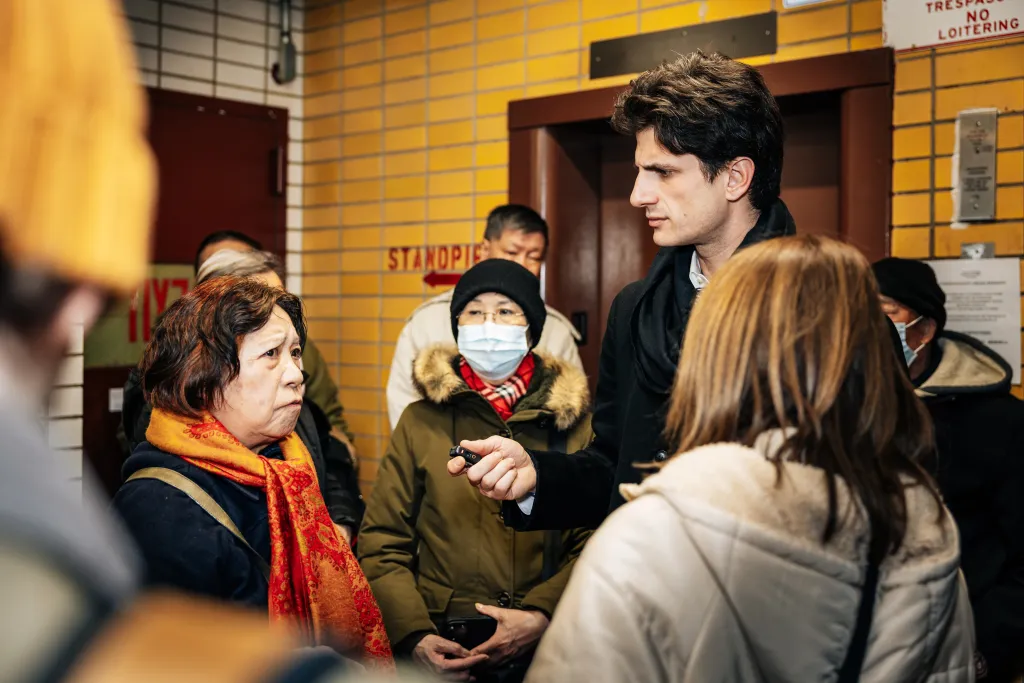 Jack Schlossberg speaking with tenants at the Elliot-Chelsea NYCHA housing complex.