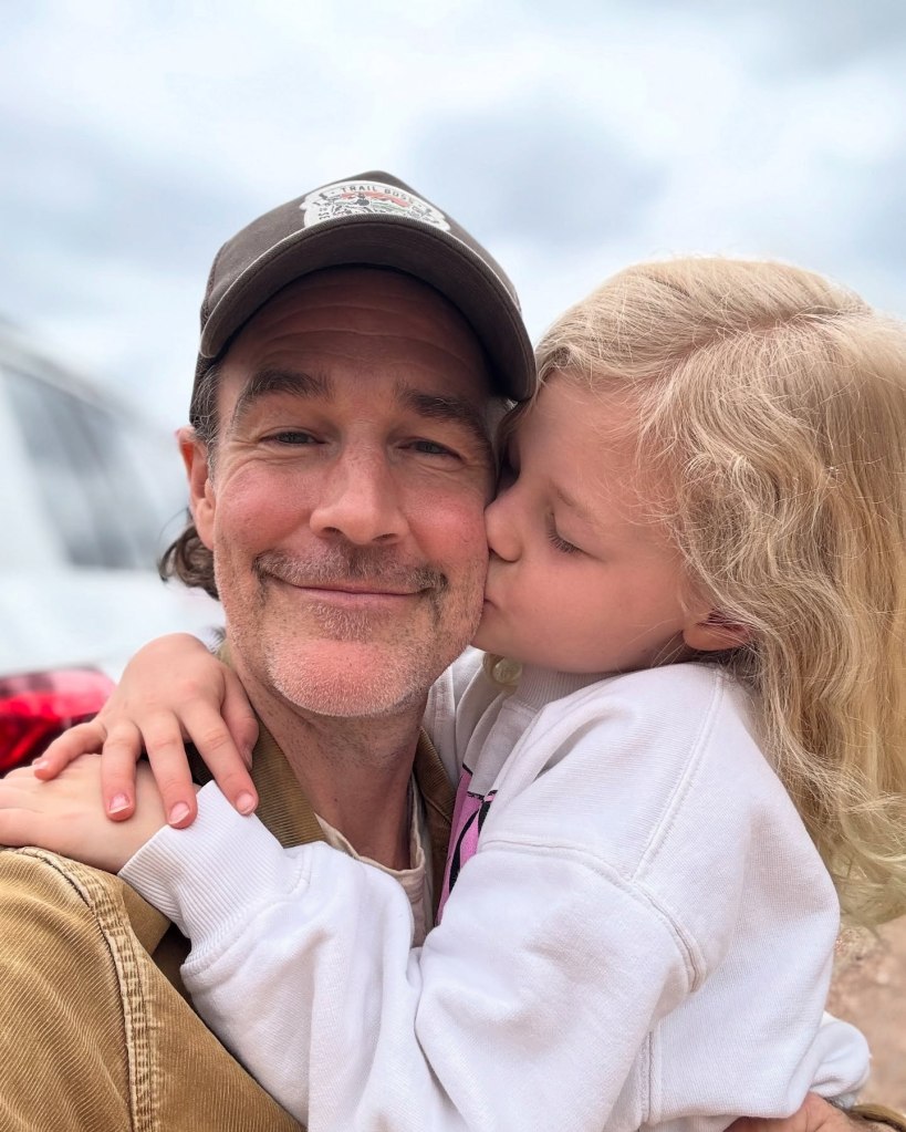 James Van Der Beek with his daughter Emilia kissing his cheek.
