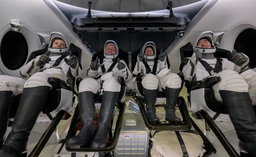 Roscosmos cosmonaut Oleg Platonov, Mike Fincke, Zena Cardman, and JAXA astronaut Kimiya Yui sit inside the return capsule during their return from the International Space Station on Jan. 15, 2026.