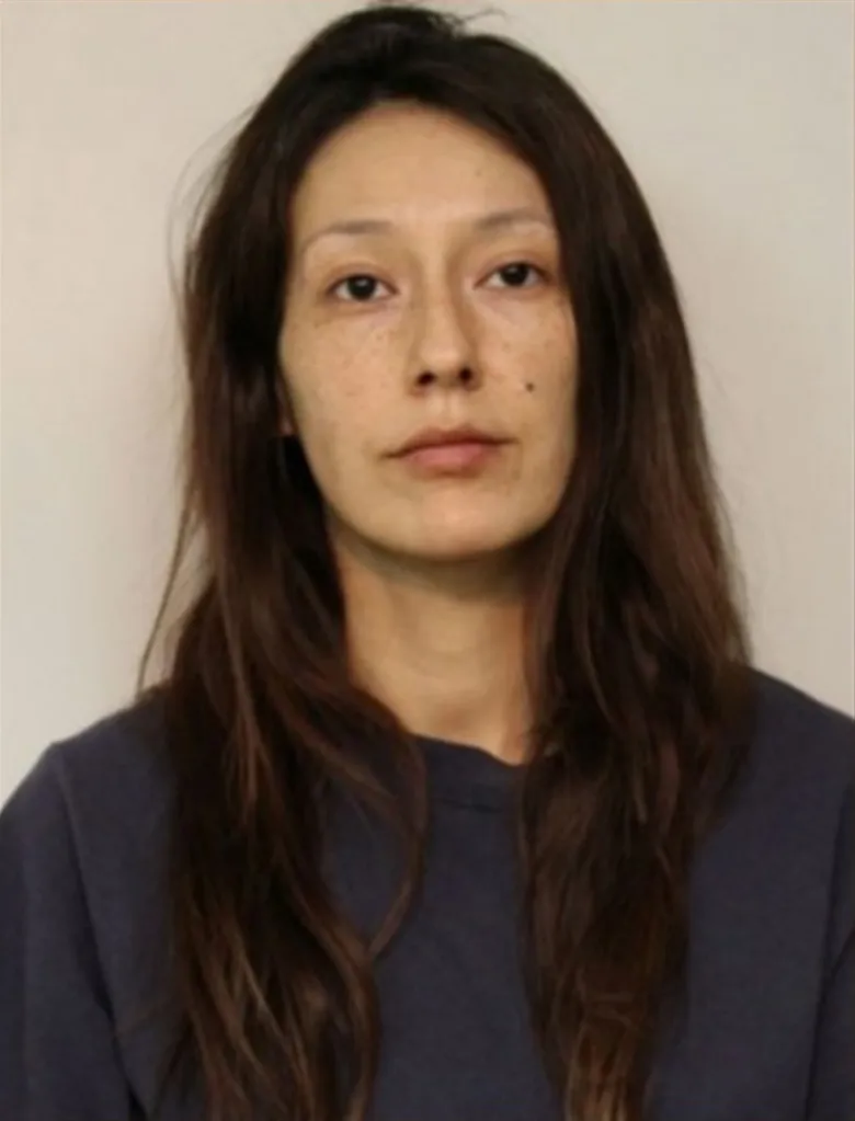 Mugshot of Jennifer Marie Stately, a woman with long dark hair, wearing a dark shirt.