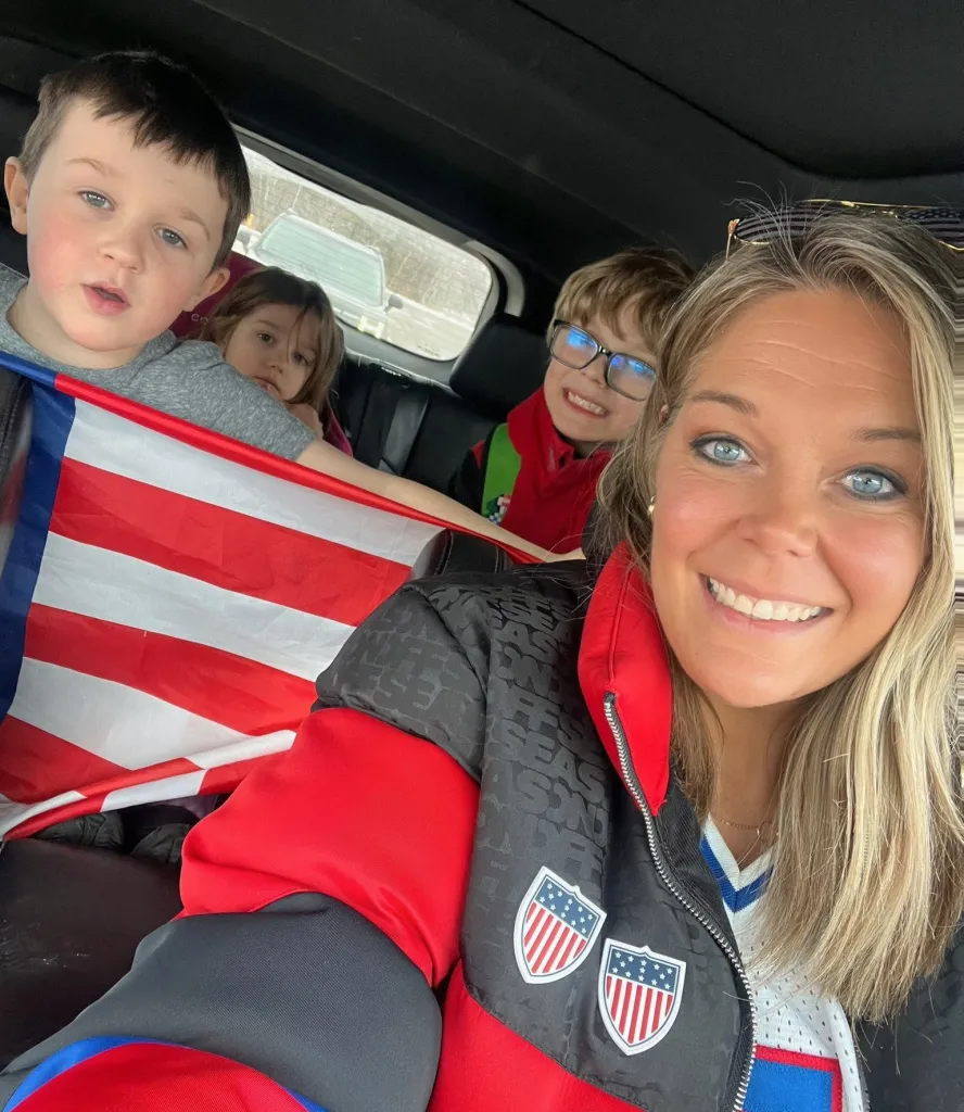 Jessi Pierce and three children in a car, with an American flag draped over the seat.