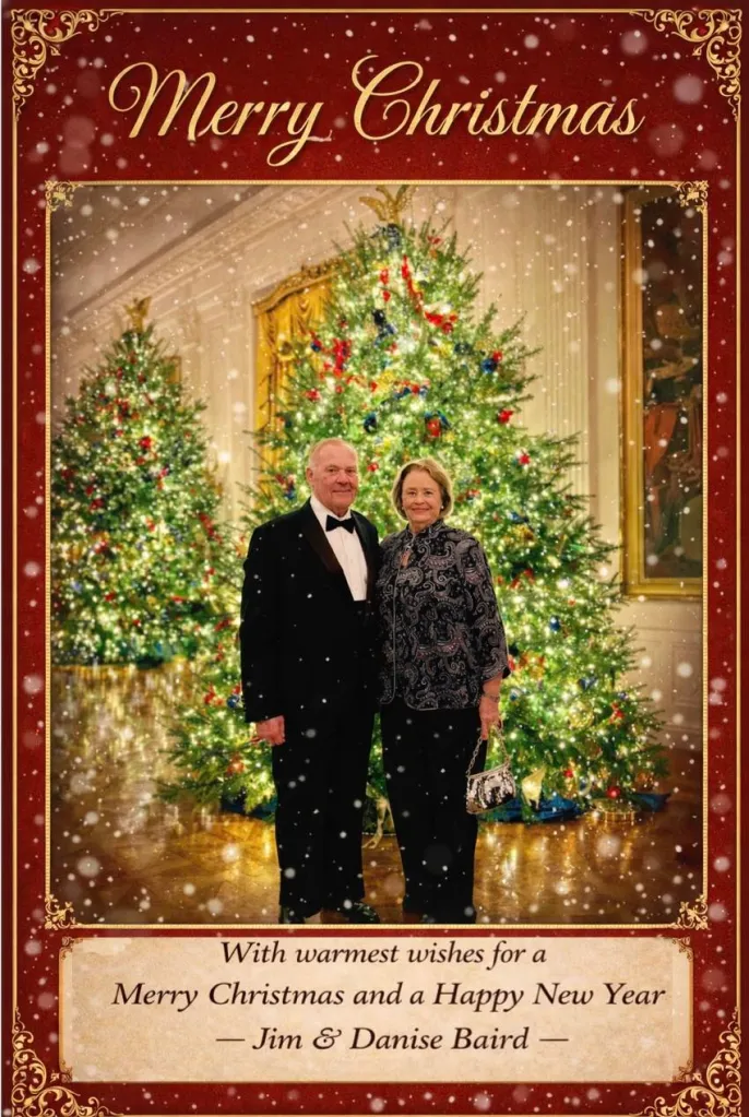 Jim and Danise Baird in formal wear in front of two decorated Christmas trees.