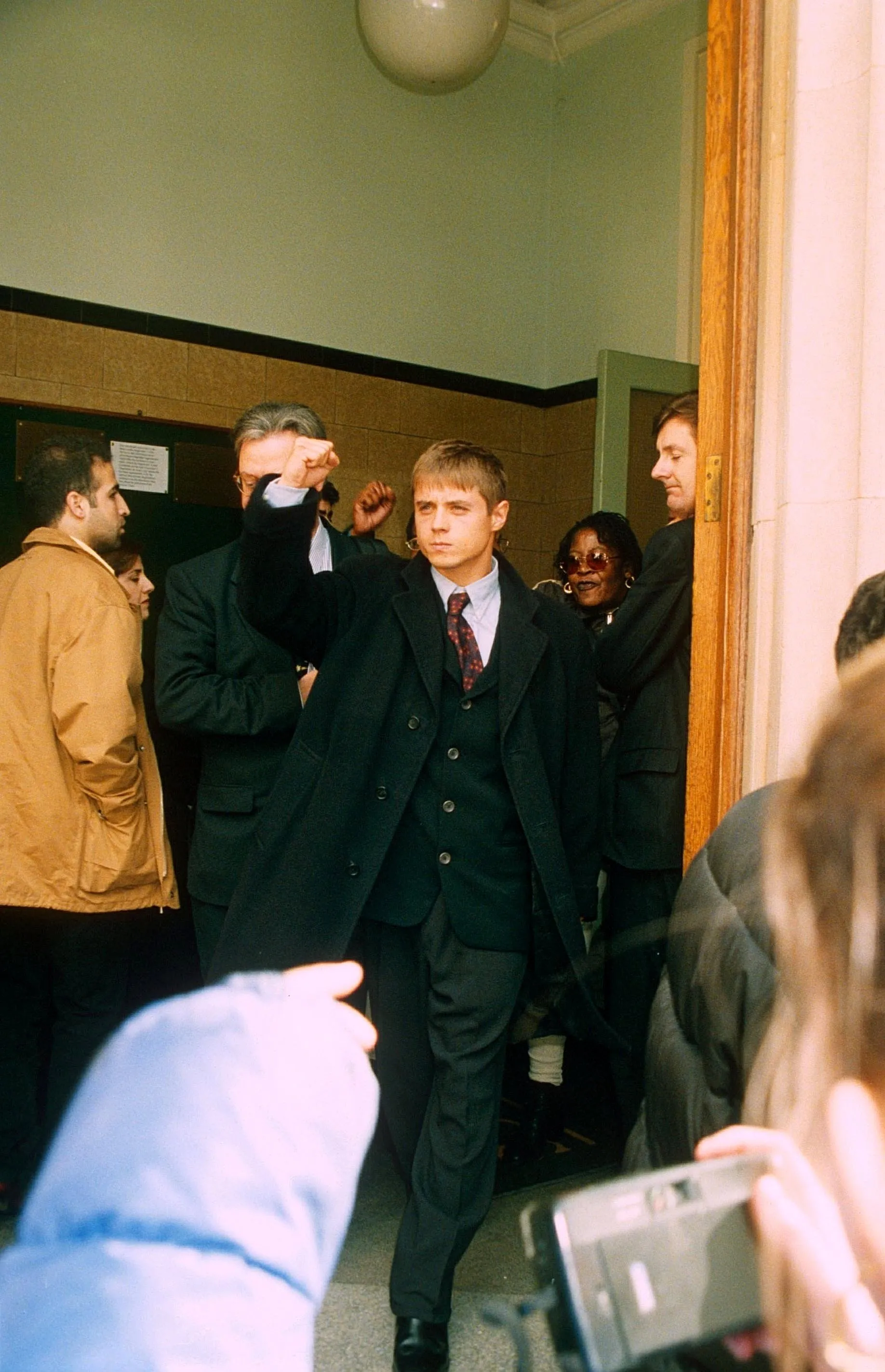 John Alford leaves court, punching the air with his fist.