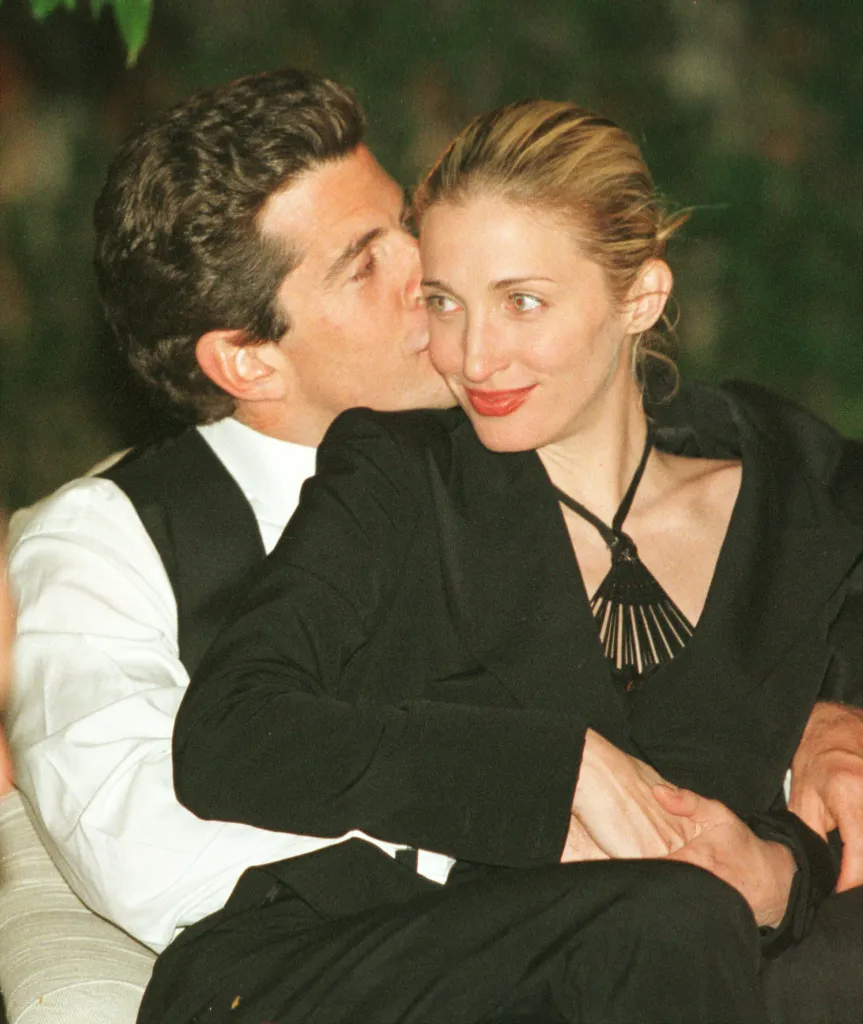 John F. Kennedy Jr. kissing Carolyn Bessette on the cheek.