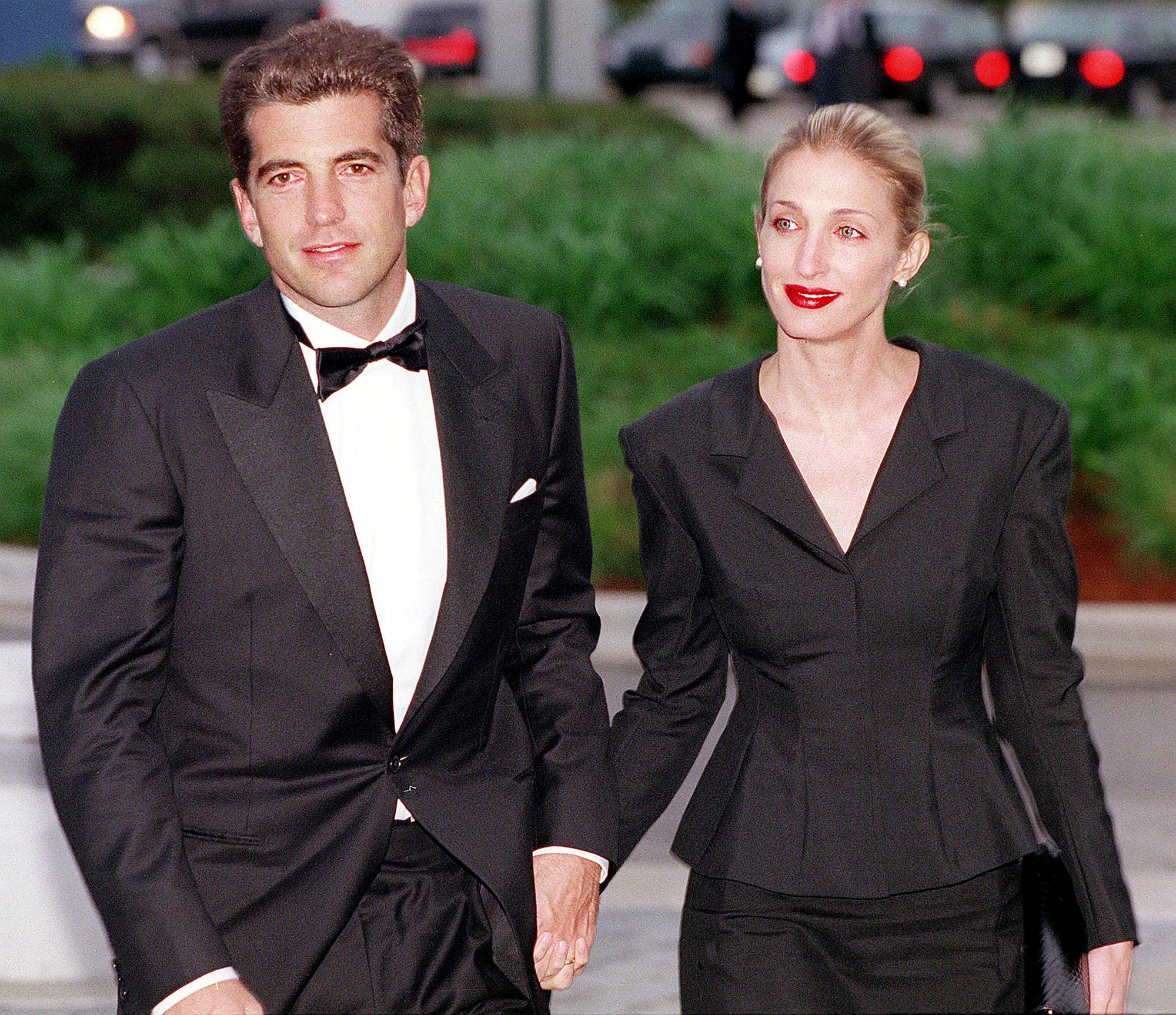 John F. Kennedy Jr. and Carolyn Bessette Kennedy holding hands at the Kennedy Library in Boston.