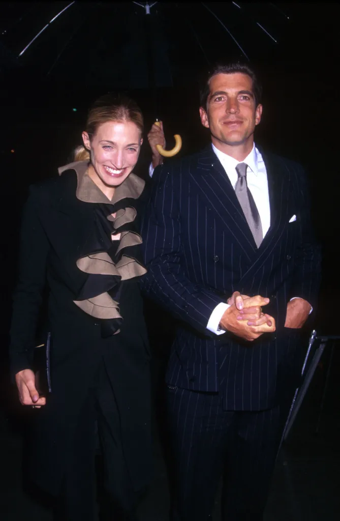 John Kennedy Jr. and his wife Carolyn Bessett under an umbrella at the Newman's Own/George Awards.