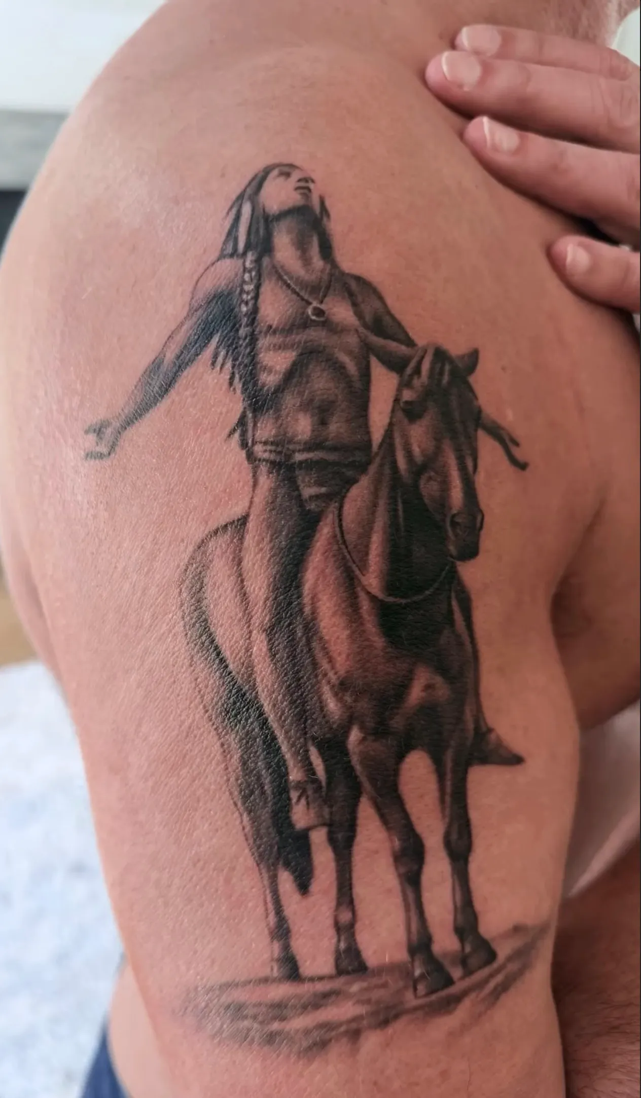 John Stamos shows off his first tattoo, a Native American horseback rider looking skyward.