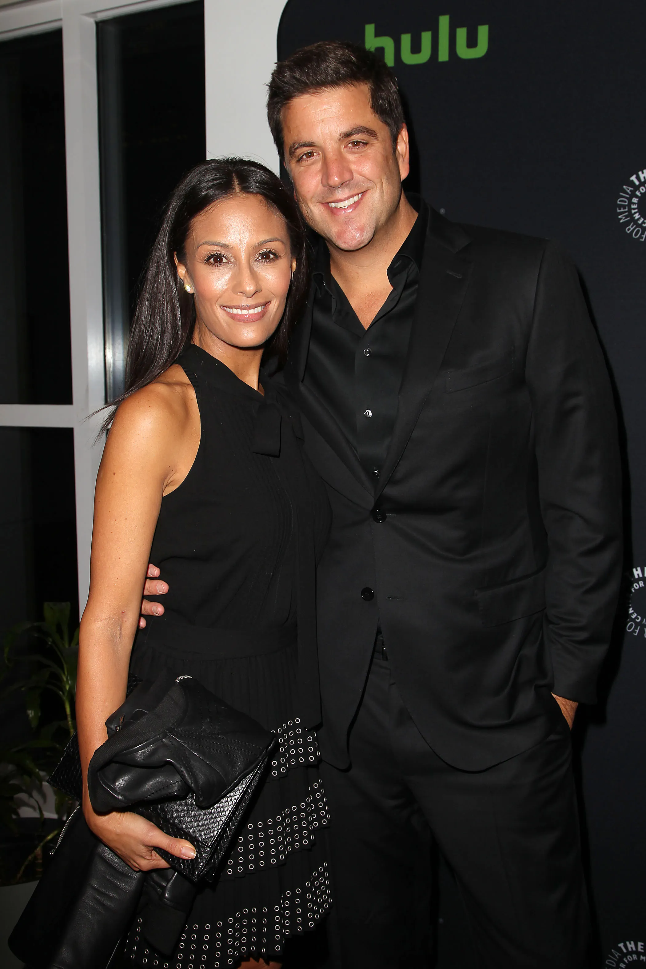 Josh Elliott and Liz Cho smile for a photo.