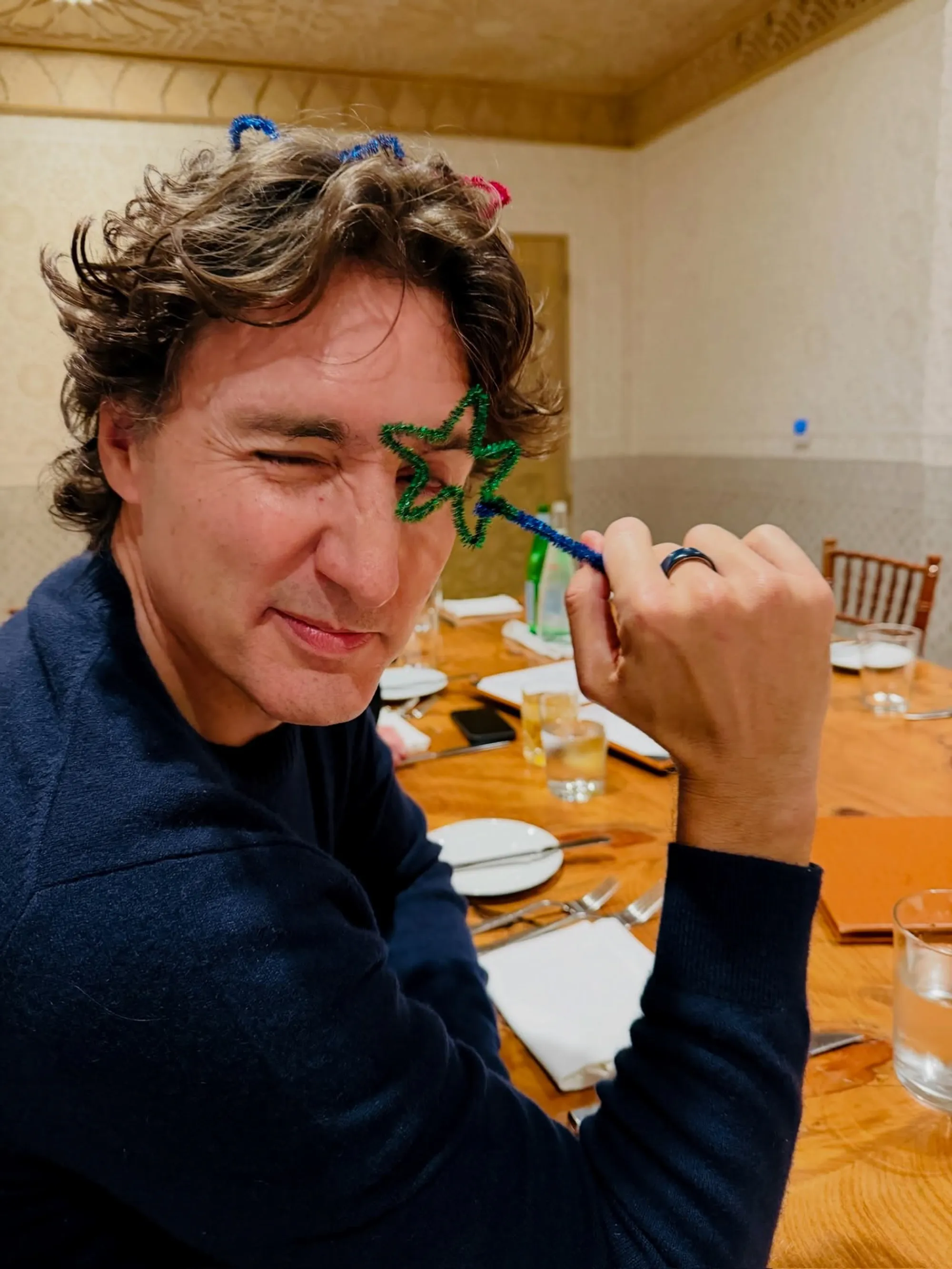 Justin Trudeau with a green pipe cleaner star over his left eye.
