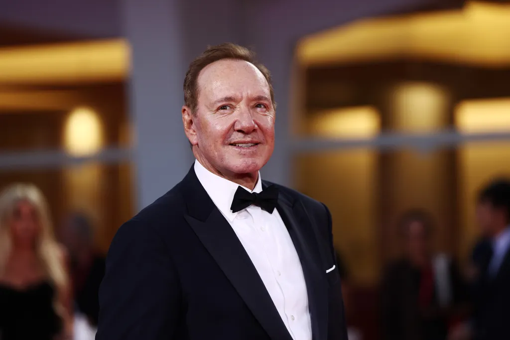 Kevin Spacey smiling and wearing a tuxedo at the Filming Italy Venice Award.