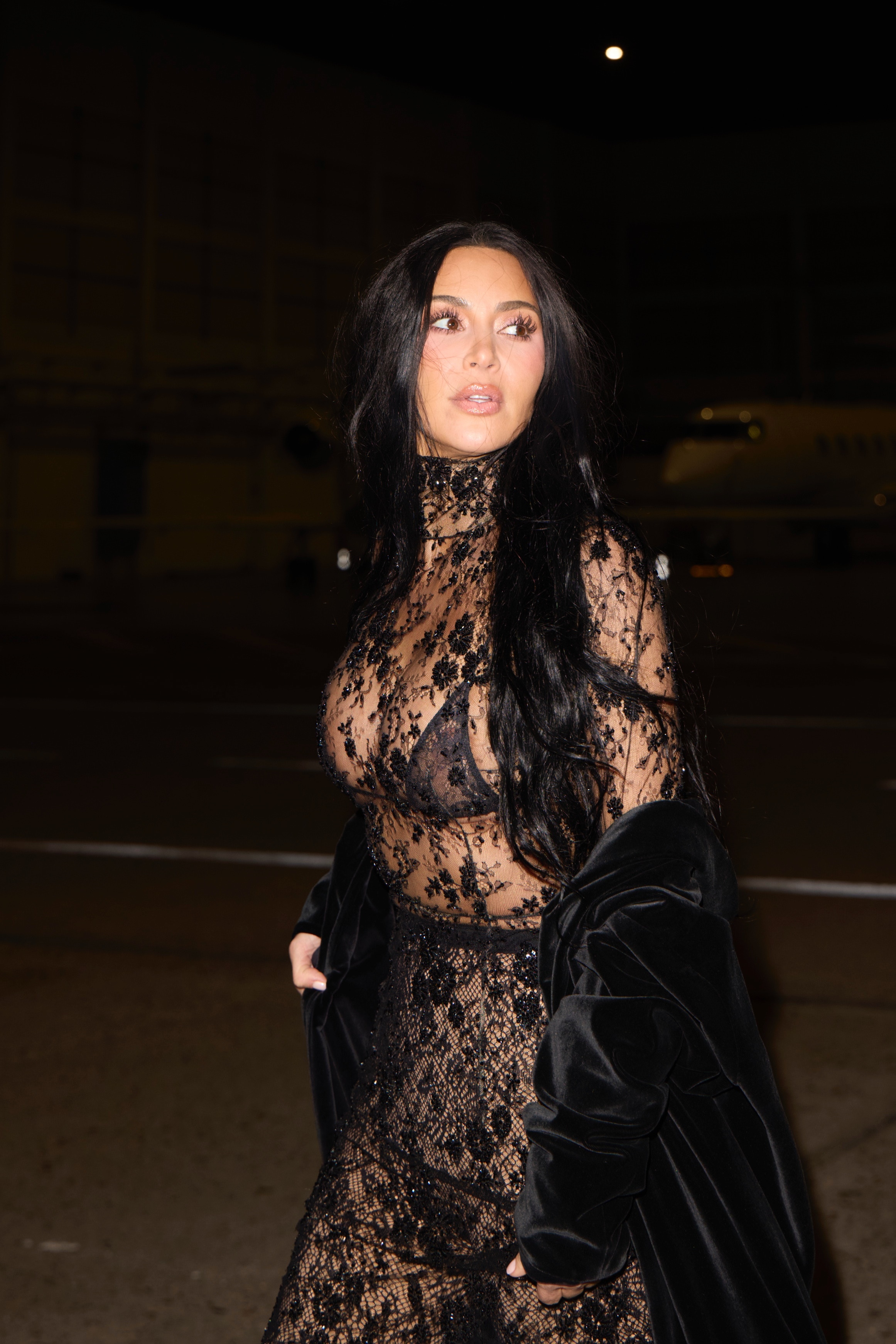 Kim Kardashian in a black lace Balenciaga dress with a Skims bra.