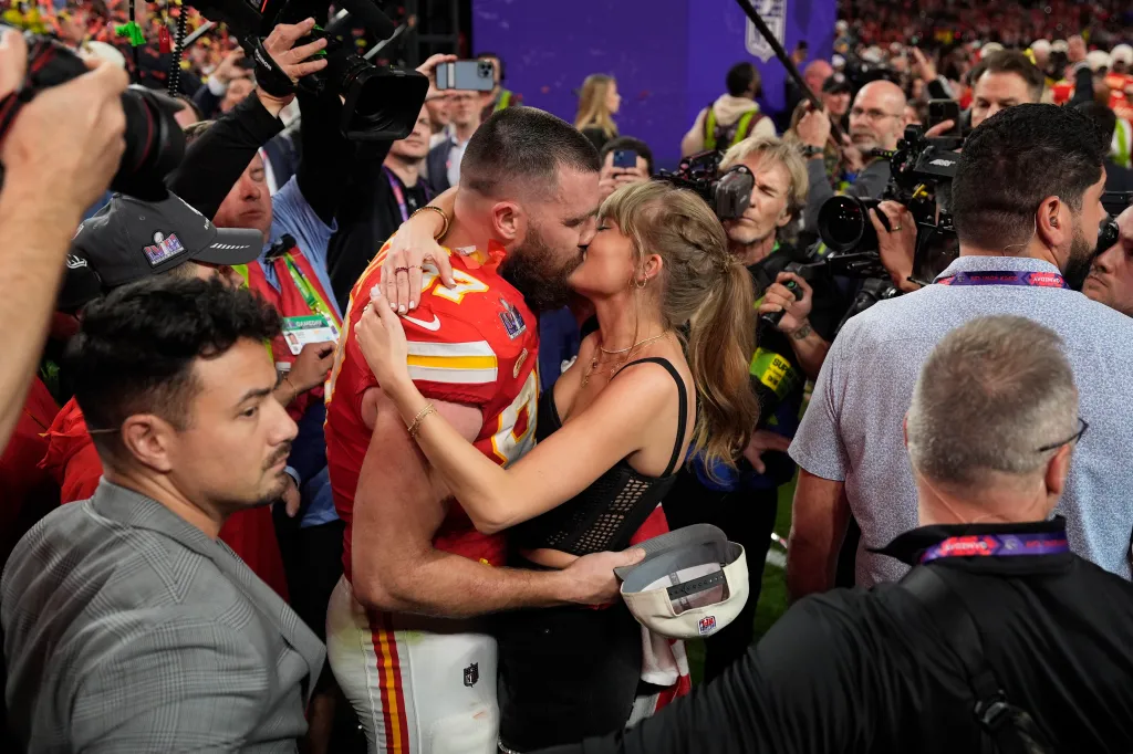 Travis Kelce and Taylor Swift kiss after the Kansas City Chiefs win Super Bowl 58.