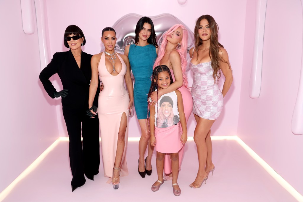 Kris Jenner, Kim Kardashian, Kendall Jenner, Stormi Webster, Kylie Jenner, and Khloé Kardashian posing in front of a pink wall.