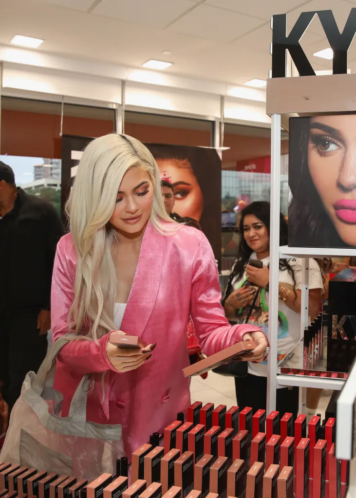 Kylie Jenner looking at Kylie Cosmetics products at Ulta Beauty.