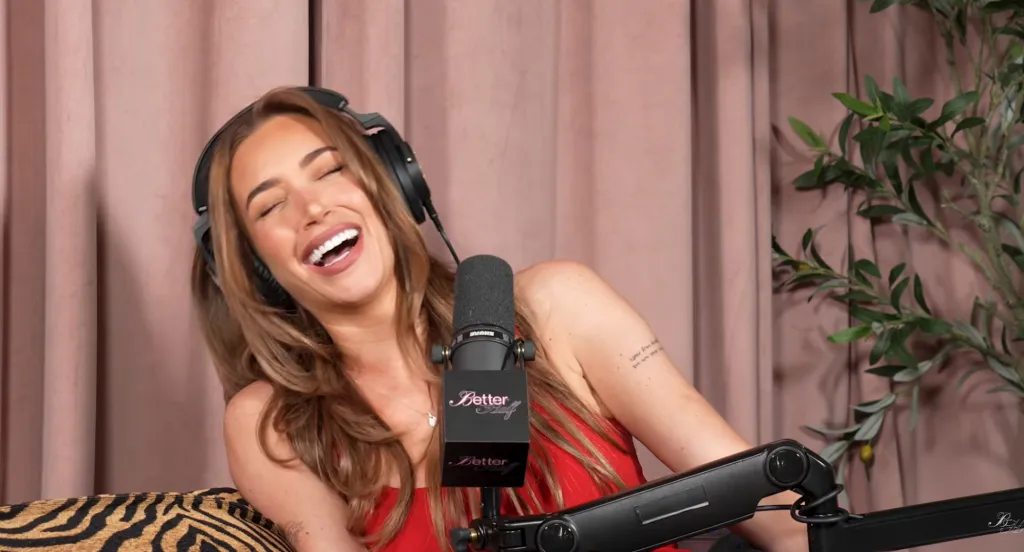 Victoria Villarroel laughing while wearing headphones and speaking into a microphone.