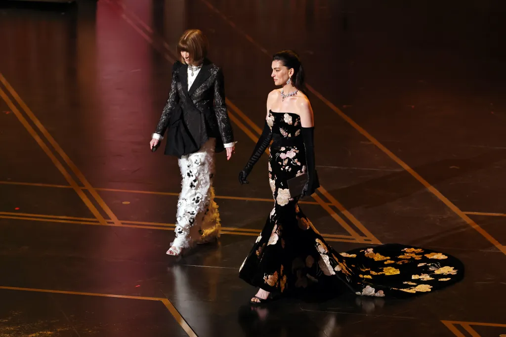 Anna Wintour and Anne Hathaway speak onstage at the 98th Oscars.