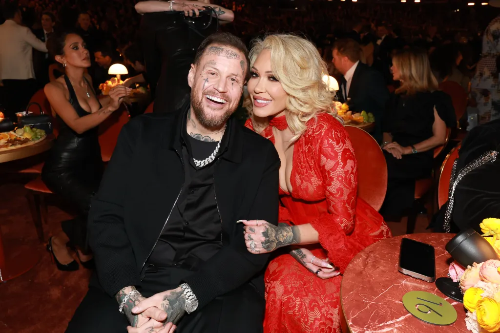 Jelly Roll and Bunnie Xo smiling while attending the 68th GRAMMY Awards.