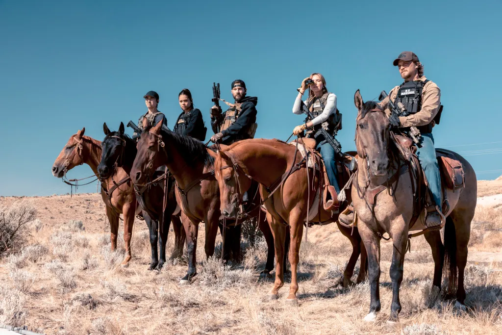 Tatanka Means as Miles, Ash Santos as Andrea, Logan Marshall-Green as Pete Calvin, Arielle Kebbel as Belle, and Luke Grimes as Kayce Dutton, from the CBS series MARSHALS, riding horses while armed.