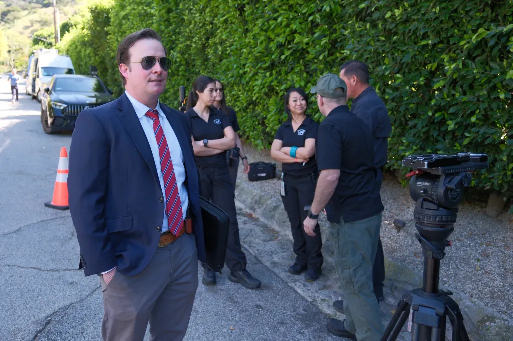 LAPD forensics team and camera crew working outside Rihanna's Beverly Hills house.