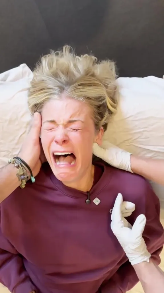 LeAnn Rimes crying during deep jaw release therapy.