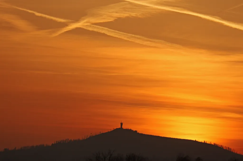 Red sky with contrails from Saharan dust over the Wurmberg in Lower Saxony at sunset.