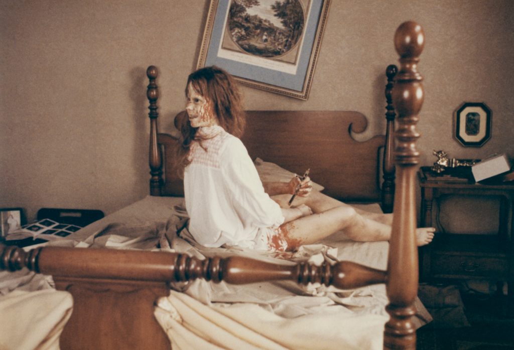 famous scene of Linda Blair's character being possessed on a bed with her head turned backwards