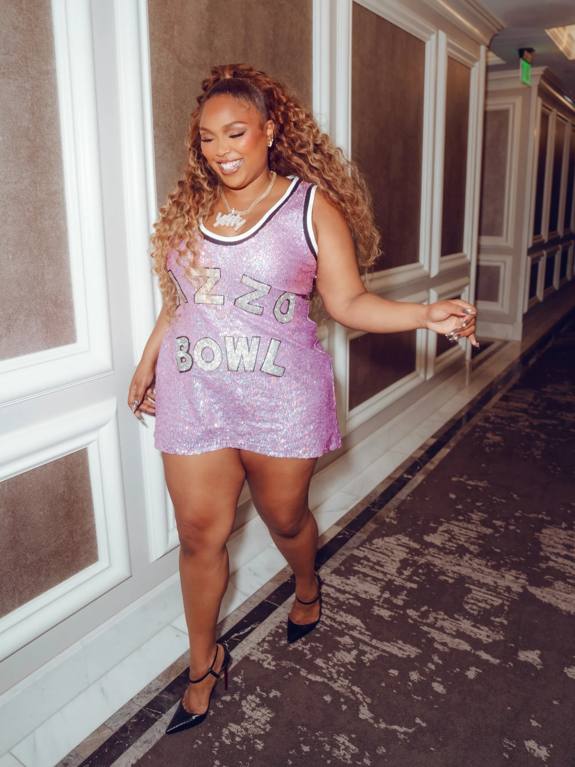 Lizzo showed off her slimmer figure in a sparkly mini dress on Friday, as seen above.