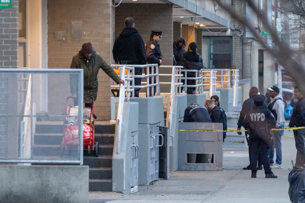 NYPD officers investigating a crime scene where a 9-year-old was shot in Brooklyn.