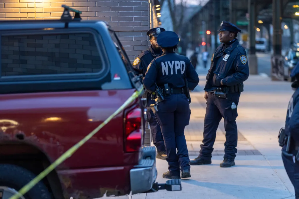 NYPD officers at the scene of a shooting in Brooklyn.