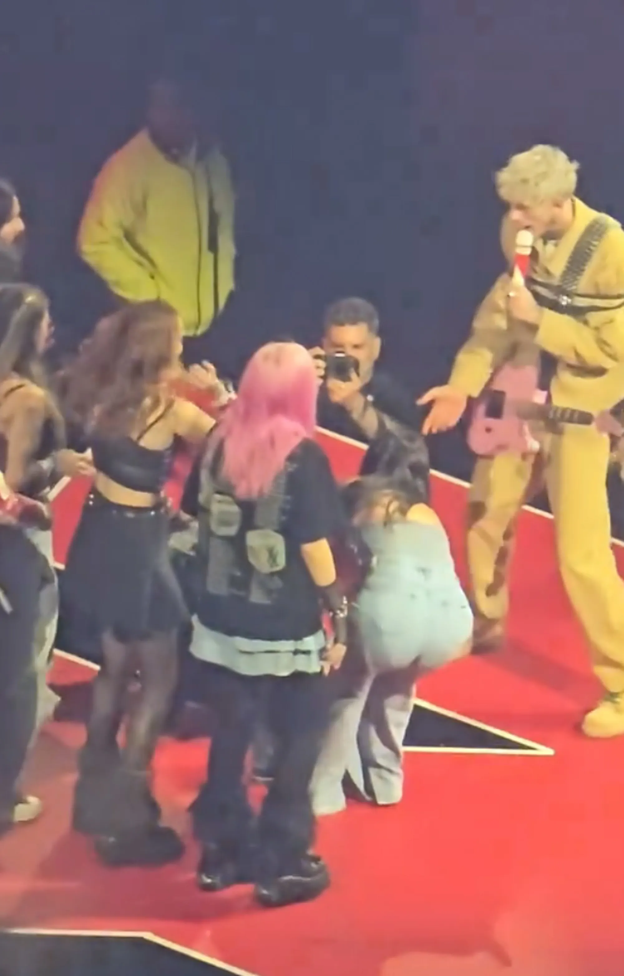 MGK and other concertgoers got her out of the hole and she continued to dance around the stage.