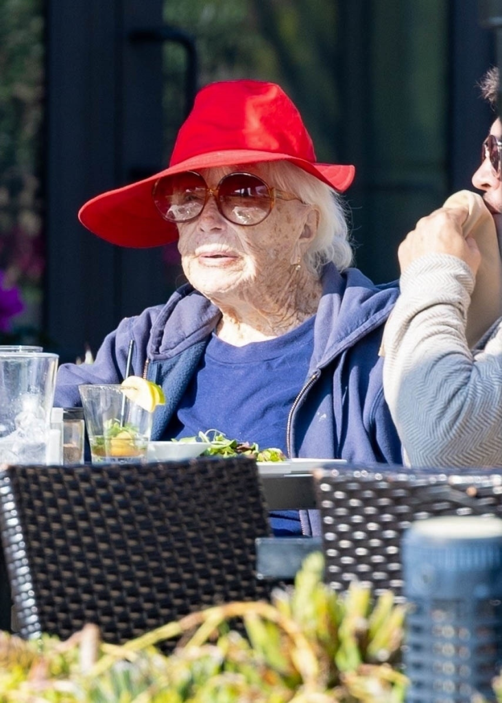 Shirley MacLaine in a red hat and sunglasses at Kristy's restaurant.