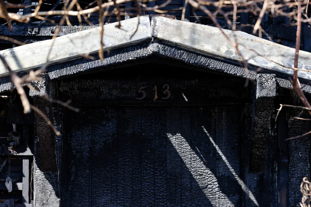 The burnt remains of the Galicia home, showing the address number 