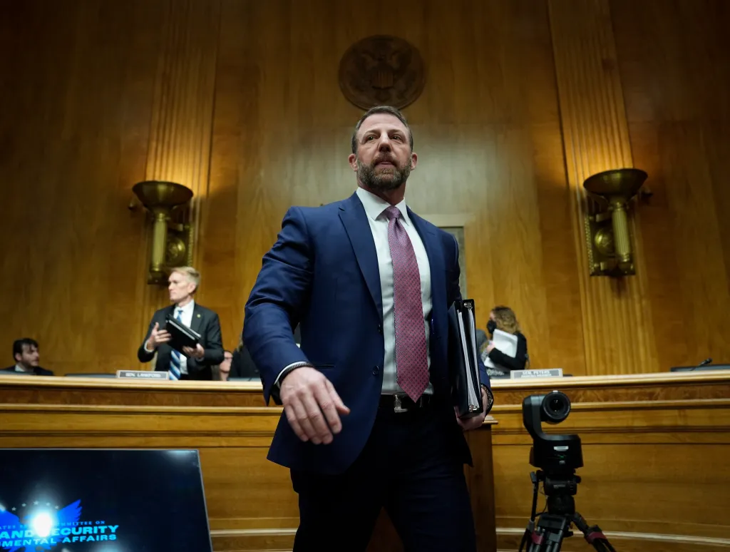 Markwayne Mullin walking away from a Senate committee hearing.