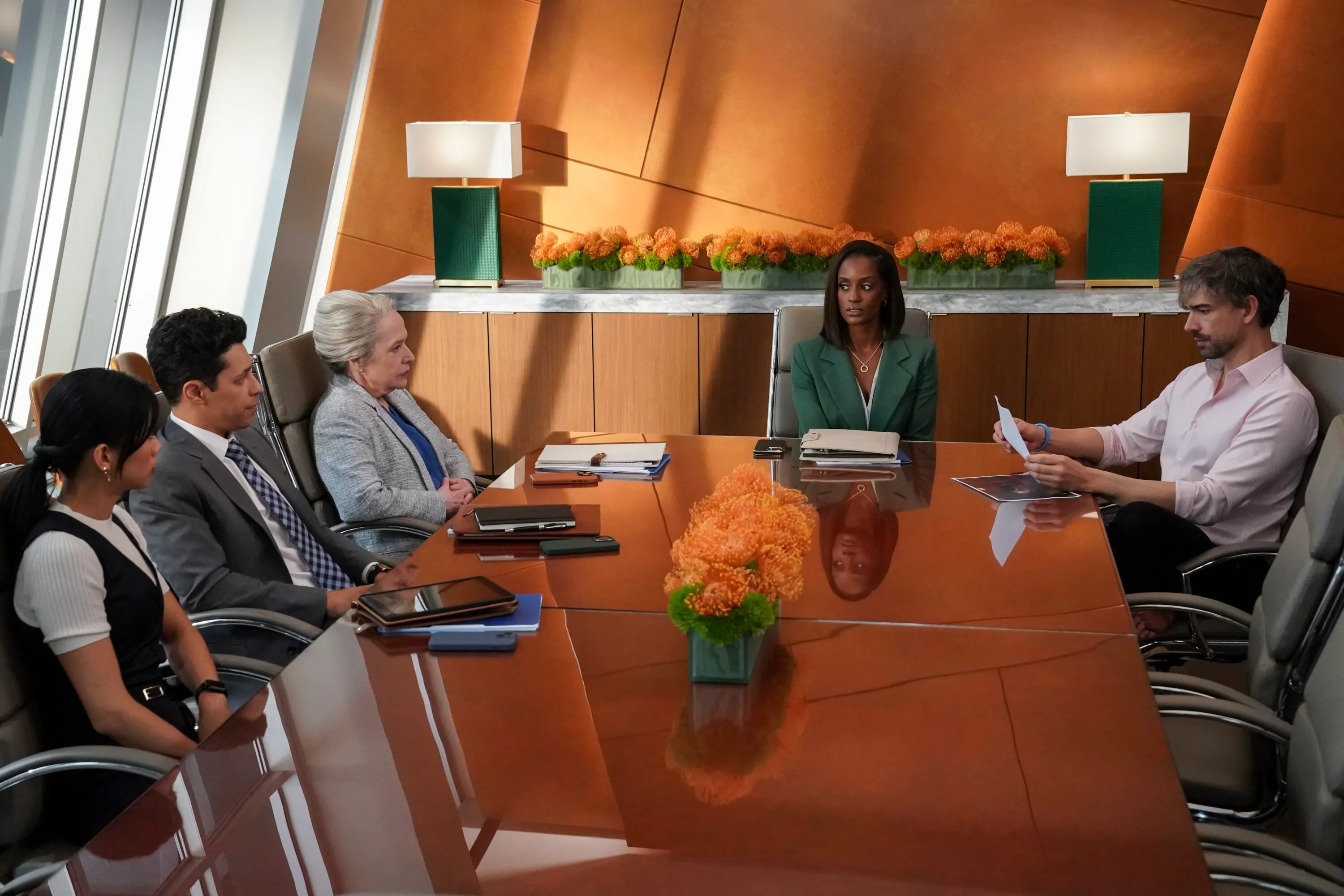 Five actors sitting around a conference table: David Del Rio, Kathy Bates, Skye P. Marshall, Leah Lewis, and Jason Ritter.