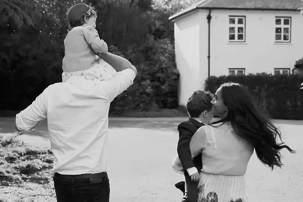Meghan Markle and Prince Harry carrying Princess Lilibet and Prince Archie.