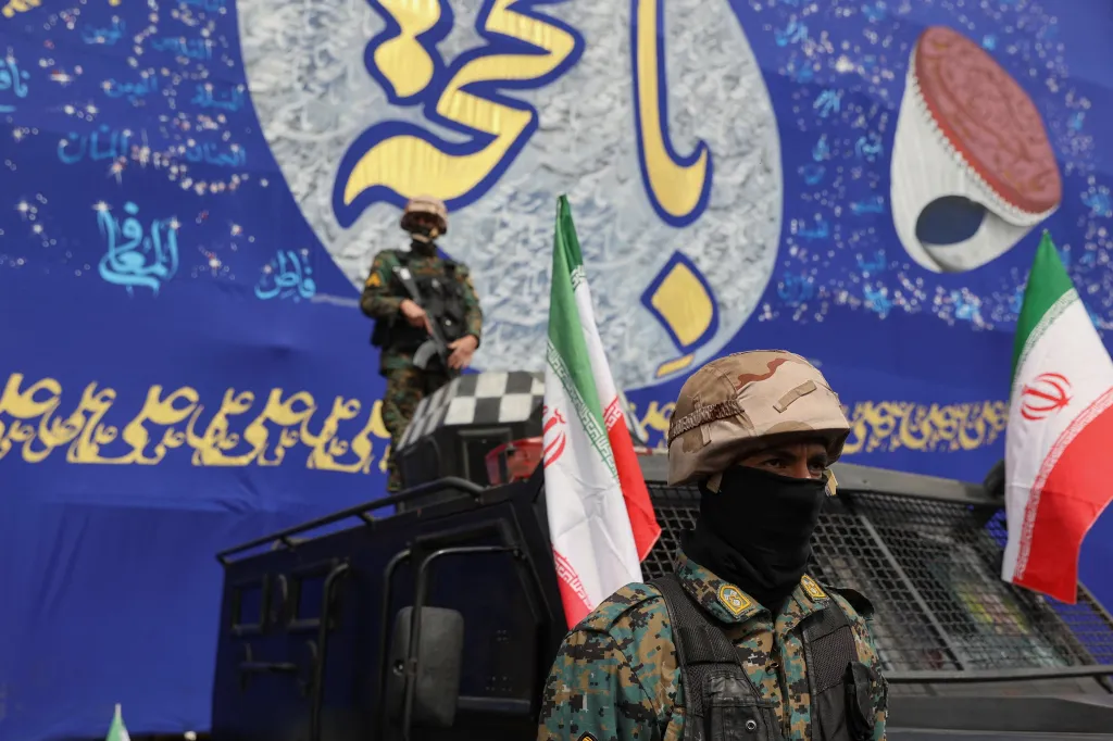 Two Iranian police officers stand guard at a funeral ceremony for Iranian military commanders.