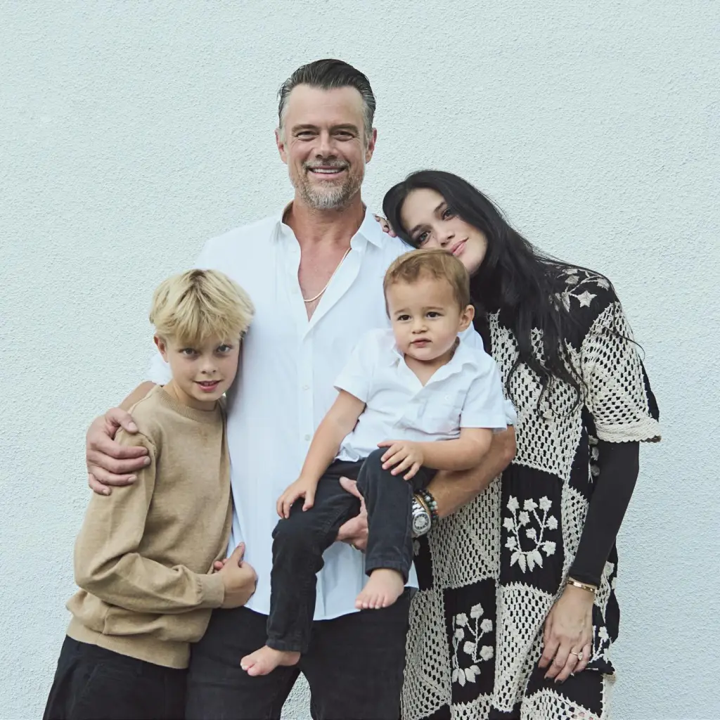 Josh Duhamel, Audra Mari, and their two sons smile for a family photo.