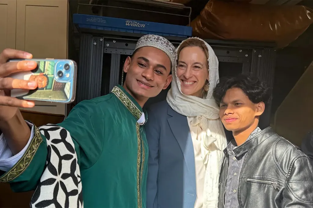 Mikie Sherrill posing for a selfie with two men at the Islamic Center of Passaic County.