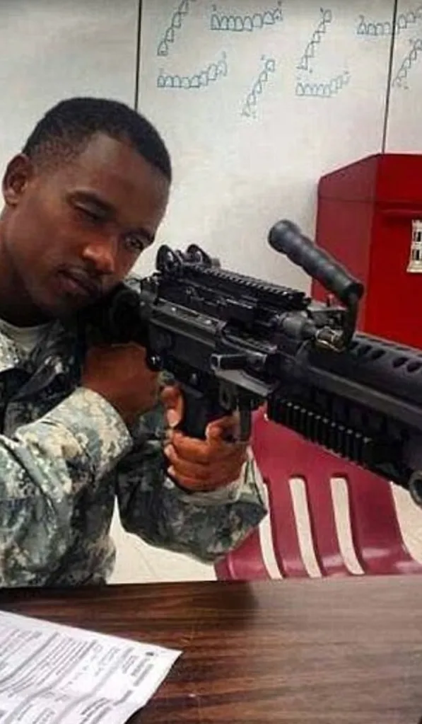 Mohamed Bailor Jalloh in uniform, holding a rifle.