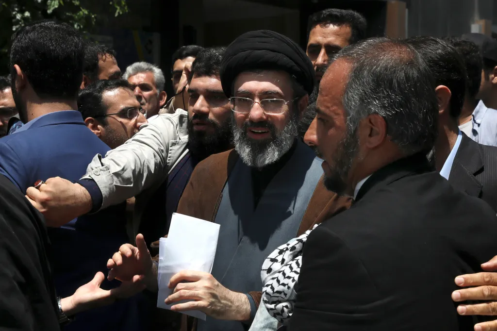 Mojtaba Khamenei, center, among a crowd of people.