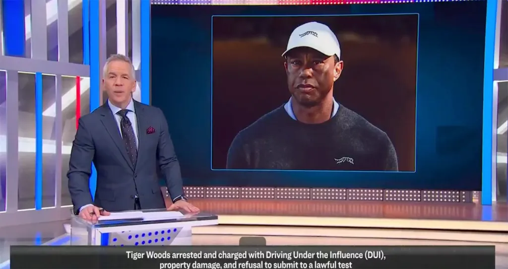 A news anchor reporting on Tiger Woods' DUI arrest with a photo of Woods on a screen beside him.